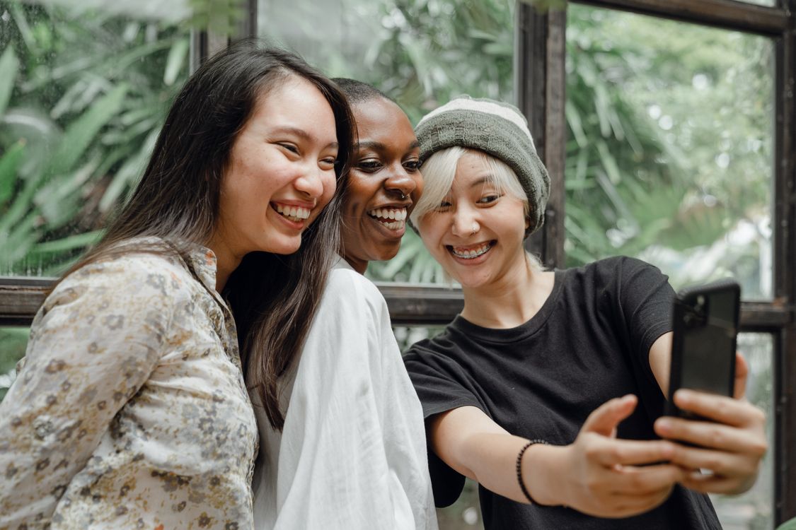 Friends sharing a moment together on a phone.