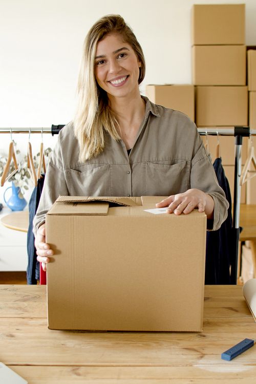 A small-business owner holding a parcel.